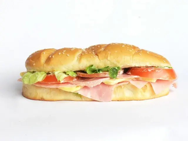 Ham, cheese, lettuce and tomato sub on a sesame roll
