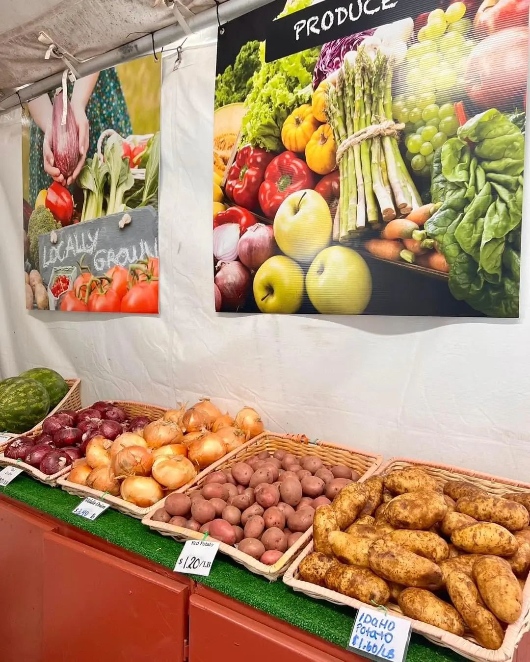 Potatoes and Onions in baskets under a Produce banner; Red Potato $1.20/lb, Idaho Potato $1.80/lb